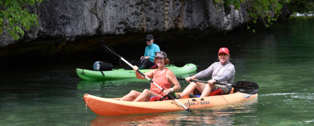 1 tandem and 1 single kayak in front of the Rock islands