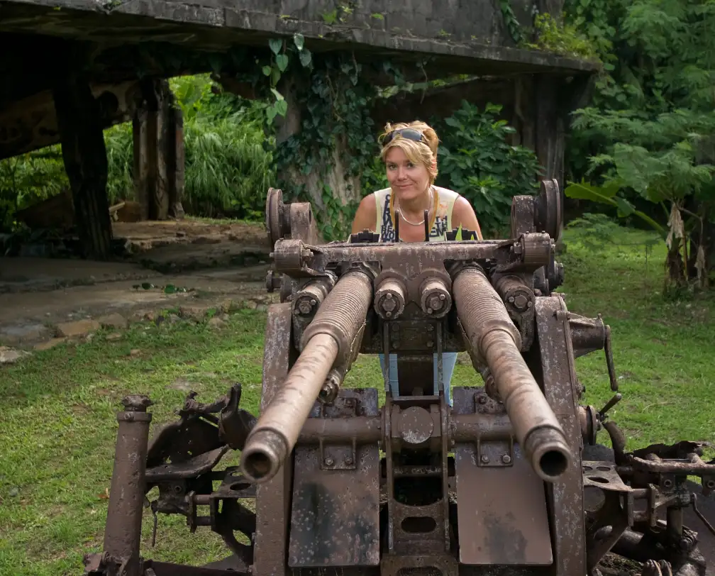 Woman behind an anti aircraft gun from WW II