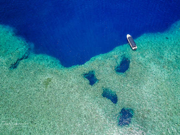 Aerial photo of a dive boat at the reef at Blue holes in Palau